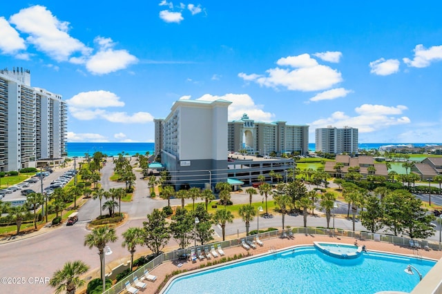 view of swimming pool with a water view and a patio