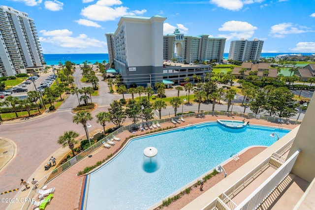 view of swimming pool with a water view and a patio area