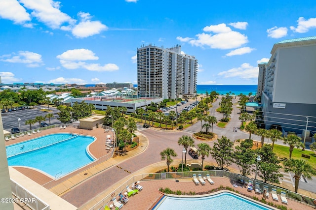 view of swimming pool featuring a patio area and a water view