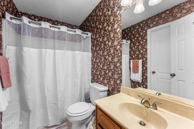 bathroom featuring vanity, toilet, and a textured ceiling