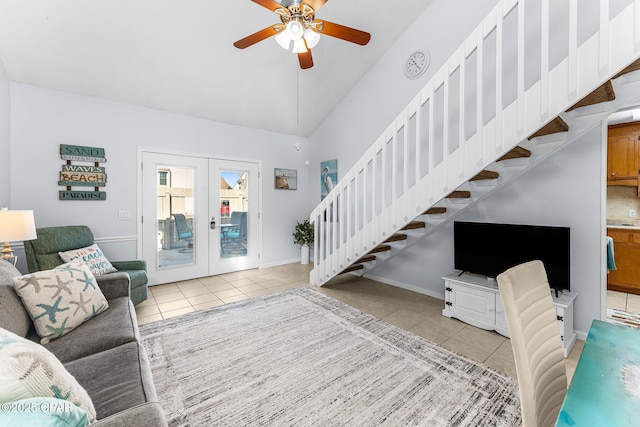 tiled living room with french doors, ceiling fan, and high vaulted ceiling