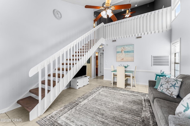 tiled living room featuring a high ceiling and ceiling fan