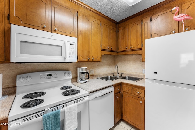 kitchen with sink, white appliances, a textured ceiling, and backsplash