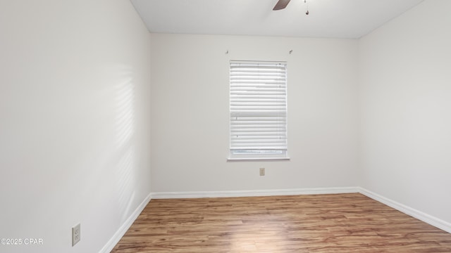 empty room with ceiling fan and light hardwood / wood-style flooring