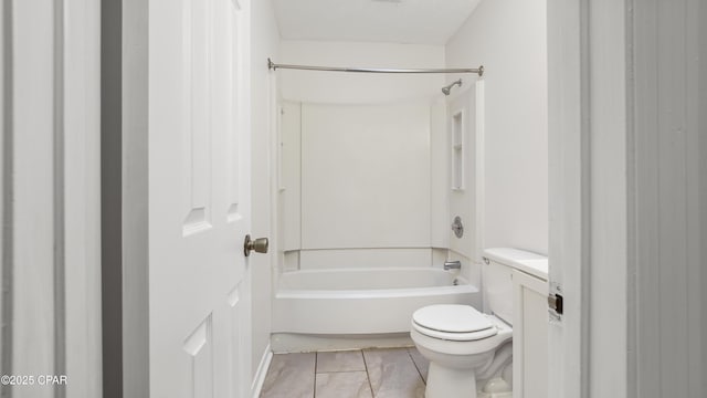 bathroom with tile patterned floors, toilet, and bathtub / shower combination