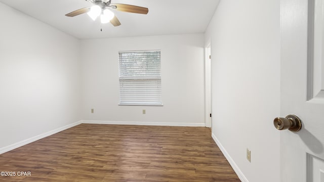 spare room with dark hardwood / wood-style floors and ceiling fan