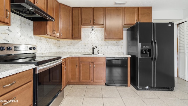 kitchen featuring light tile patterned flooring, sink, decorative backsplash, and black appliances