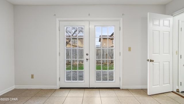 doorway with light tile patterned floors and french doors