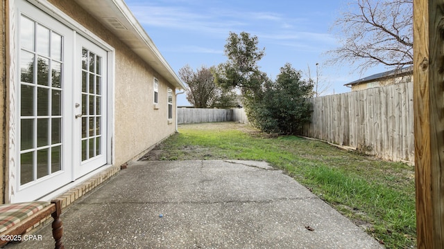 view of yard featuring a patio area and french doors