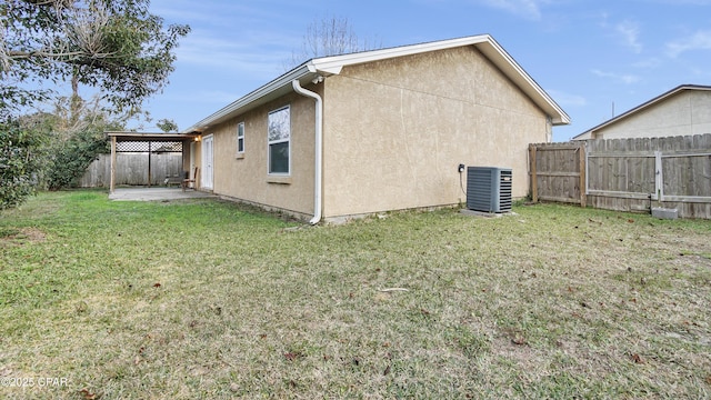 back of house featuring a patio, cooling unit, and a lawn