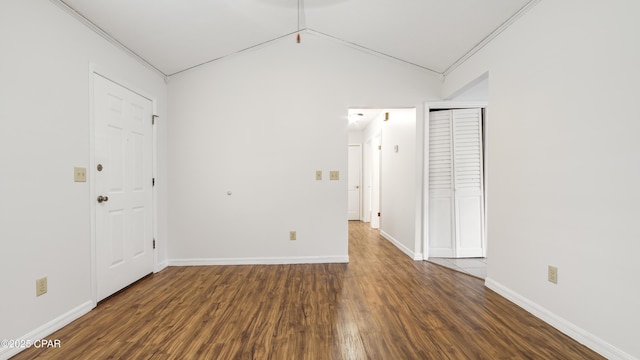 interior space with vaulted ceiling and dark wood-type flooring