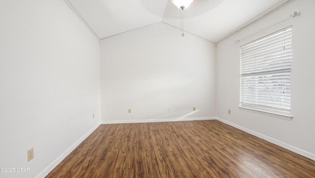 empty room featuring wood-type flooring, ceiling fan, and vaulted ceiling