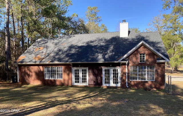 back of property featuring french doors and a lawn