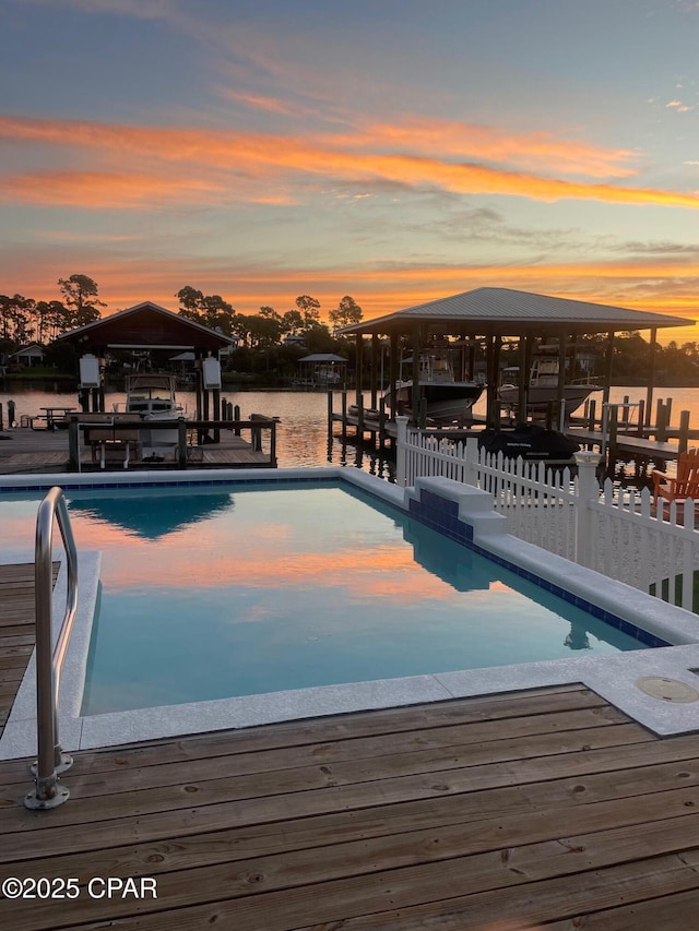 pool at dusk with a deck with water view