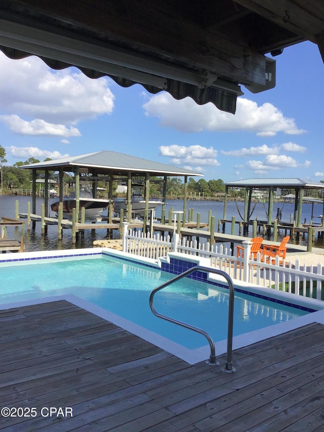 view of pool featuring a water view and a boat dock