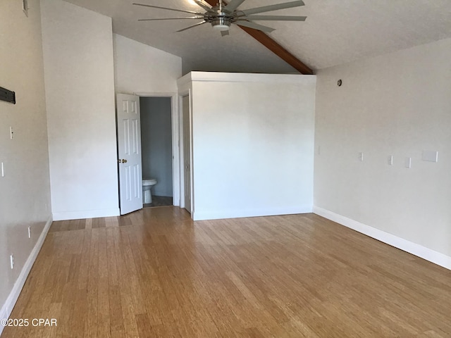 spare room featuring vaulted ceiling, ceiling fan, and wood-type flooring