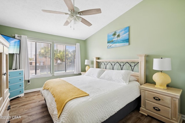 bedroom with ceiling fan, dark hardwood / wood-style flooring, and lofted ceiling