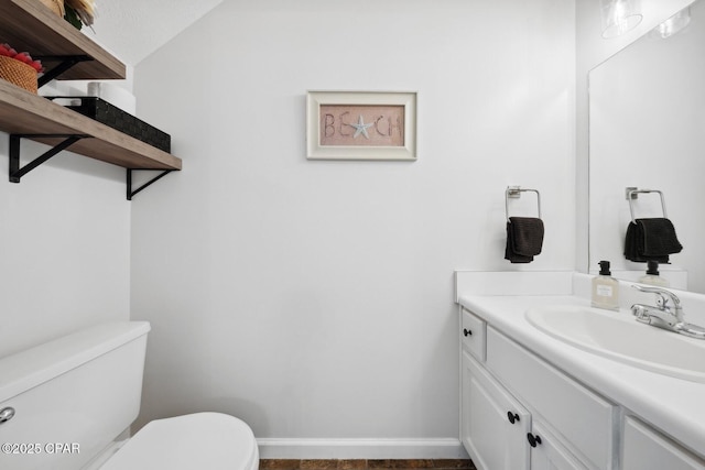 bathroom featuring toilet and vanity