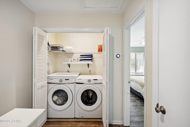 laundry area featuring washing machine and dryer and dark hardwood / wood-style floors