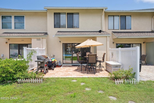 rear view of property with a patio and a yard