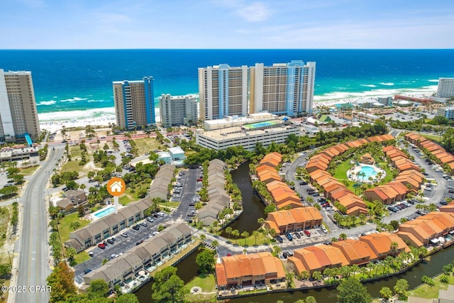 drone / aerial view featuring a beach view and a water view