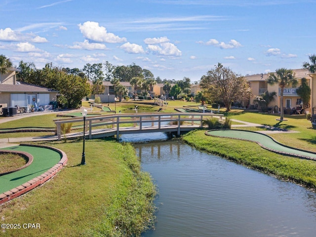 view of home's community featuring a yard and a water view