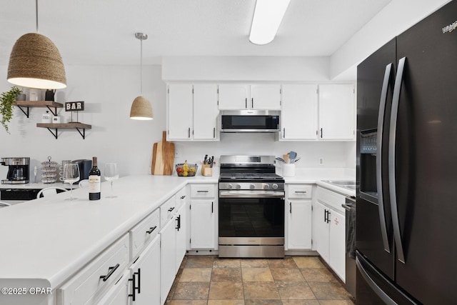 kitchen featuring white cabinets, pendant lighting, and appliances with stainless steel finishes