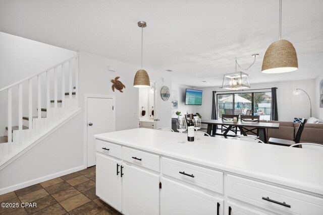 kitchen featuring white cabinetry and decorative light fixtures