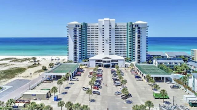 drone / aerial view with a water view and a view of the beach