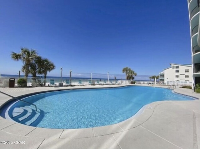 view of pool with a water view