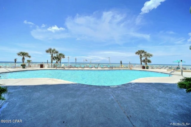 view of pool featuring a water view