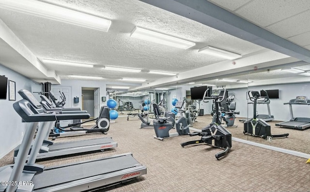 workout area with a textured ceiling and carpet floors