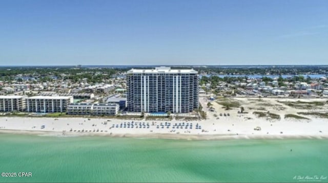 birds eye view of property with a view of the beach and a water view