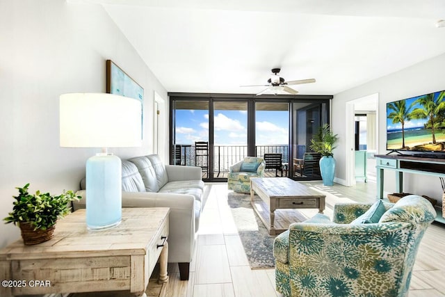 living room with floor to ceiling windows and ceiling fan