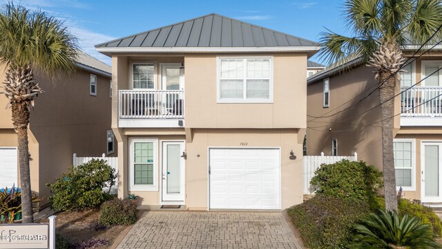 view of front of home featuring a balcony and a garage