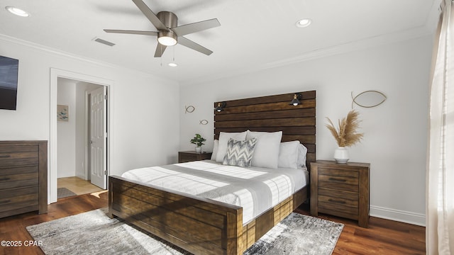 bedroom with dark hardwood / wood-style flooring, crown molding, and ceiling fan