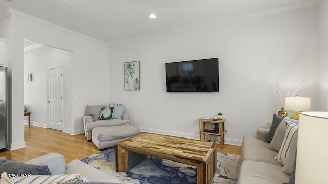 living room featuring ornamental molding and light wood-type flooring