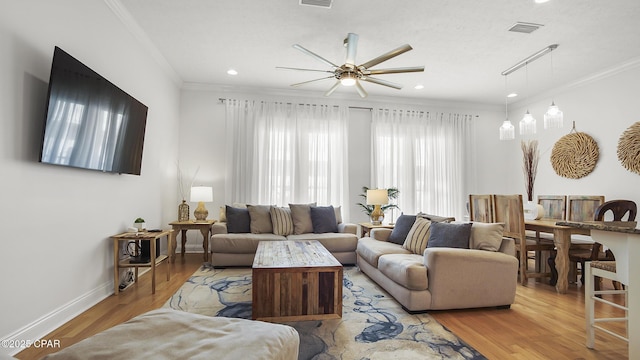 living room featuring ornamental molding and light hardwood / wood-style flooring