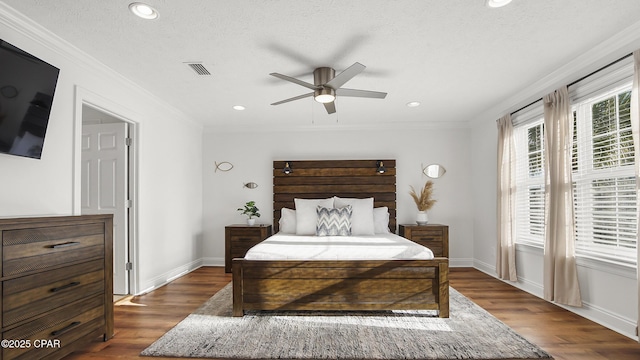 bedroom with ornamental molding, ceiling fan, a textured ceiling, and dark hardwood / wood-style flooring