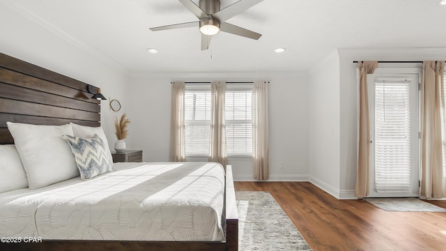 bedroom featuring dark hardwood / wood-style flooring, ornamental molding, and ceiling fan