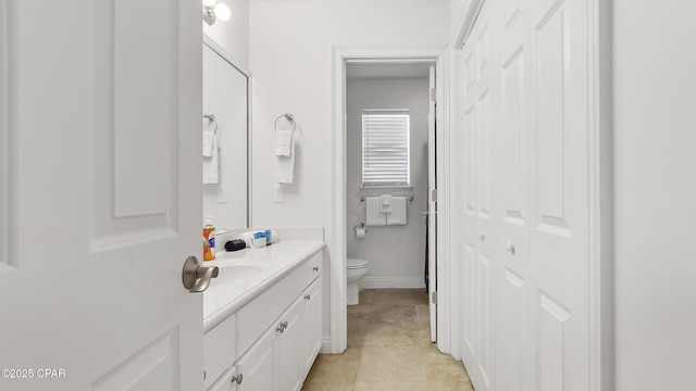 bathroom featuring tile patterned flooring, vanity, and toilet