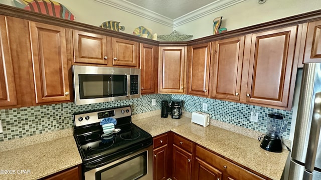 kitchen with backsplash, crown molding, and stainless steel appliances