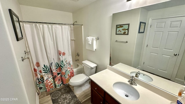 full bathroom featuring toilet, hardwood / wood-style flooring, shower / tub combo with curtain, and vanity