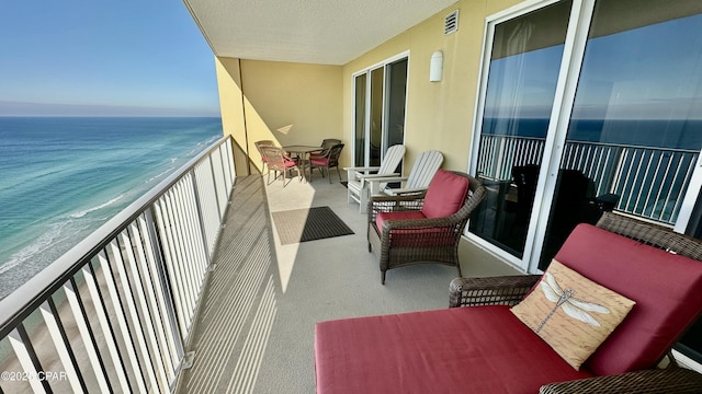 balcony with a beach view and a water view