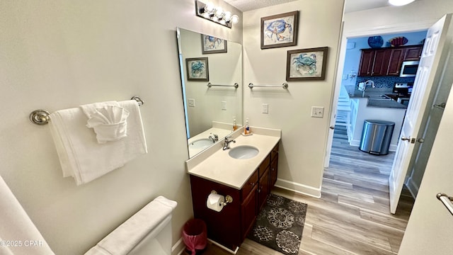 bathroom with tasteful backsplash, vanity, a textured ceiling, and hardwood / wood-style flooring