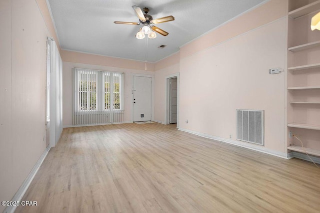 empty room featuring ceiling fan and light hardwood / wood-style floors