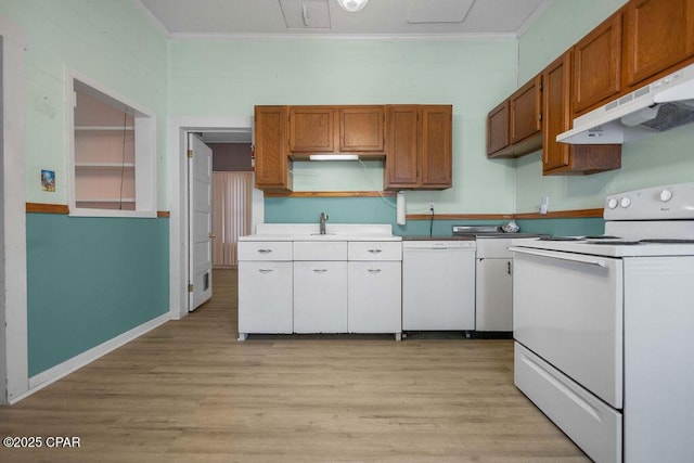 kitchen featuring white appliances, ornamental molding, and light wood-type flooring