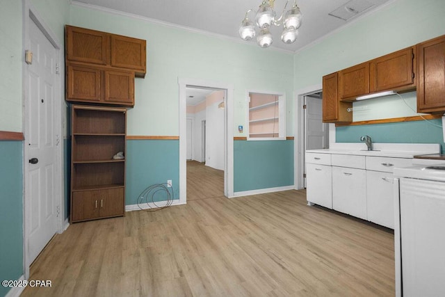 kitchen featuring light countertops, crown molding, open shelves, light wood-type flooring, and stove