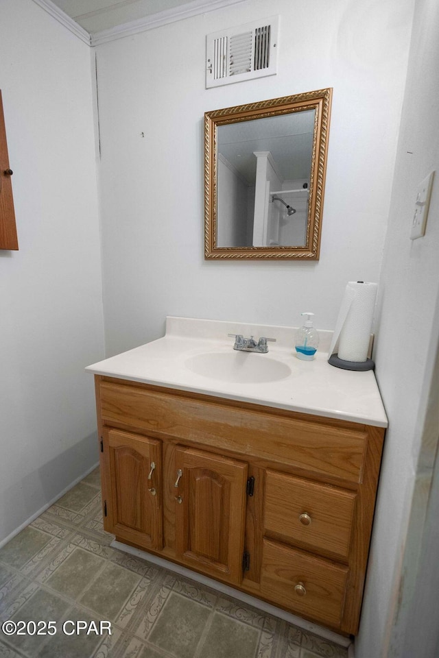 bathroom featuring ornamental molding and vanity