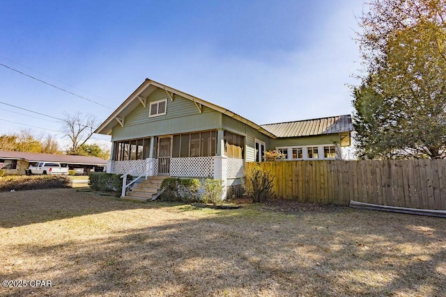 view of front of property with a front lawn and a sunroom